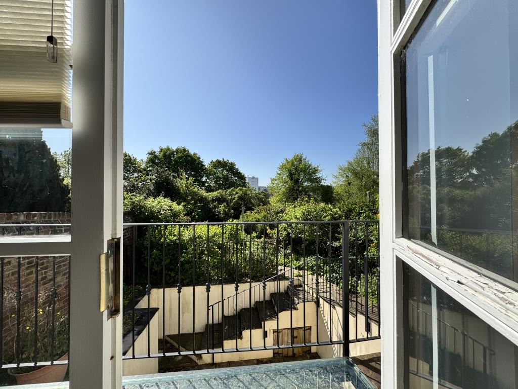 Lot: 138 - TWO-BEDROOM BUNGALOW WITH ANNEXE - Balcony looking out to the rear garden